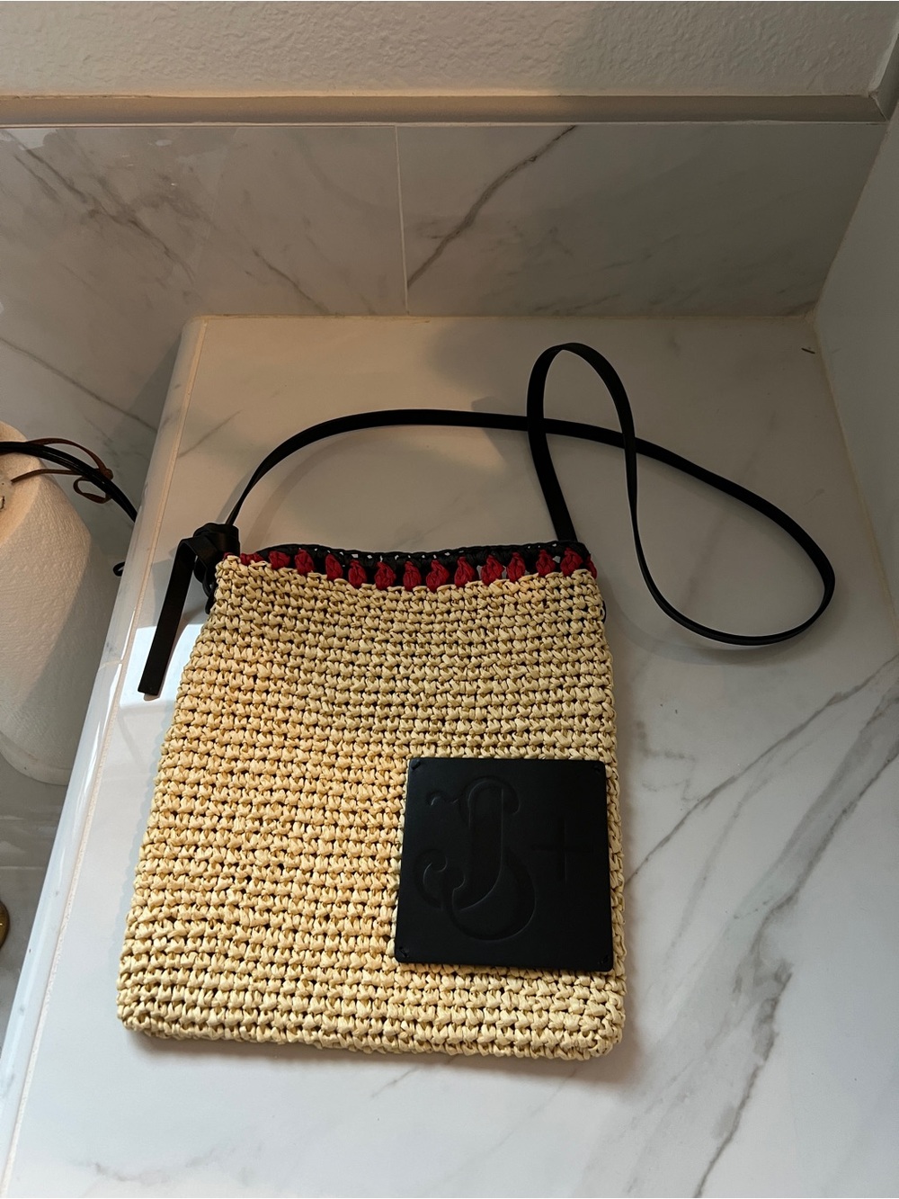 Woven Straw Crossbody Bag with Black Trim and Red Accent